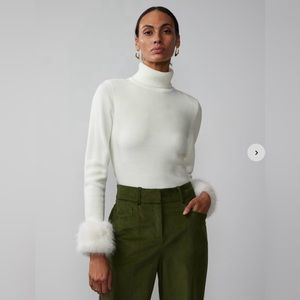 Winter white turtleneck with removable fur cuffs. New with tags.